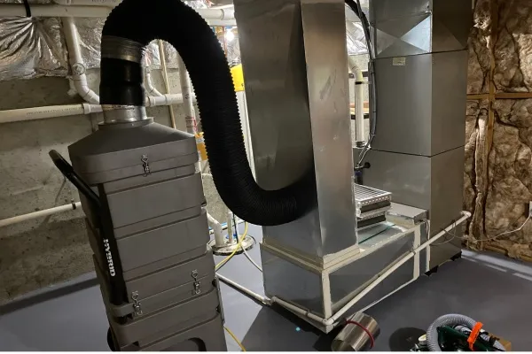 Dryer vent installation process in a basement in New Jersey with equipment and ductwork visible Dryer vent installation process in a basement in New Jersey with equipment and ductwork visible